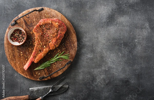 Obraz Raw Tomahawk Steak in Rub Marinade for BBQ