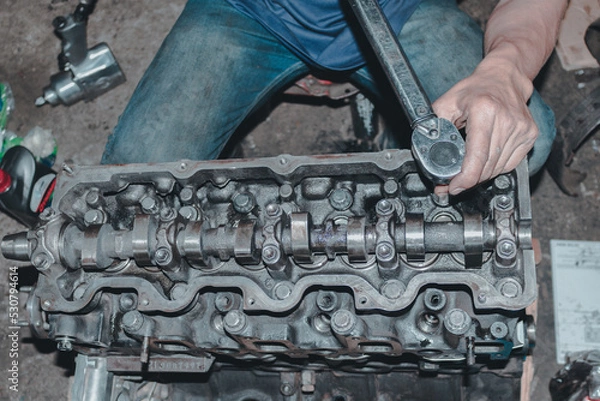 Obraz The mechanic is checking the engine.