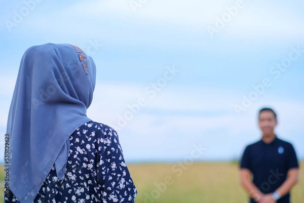 Fototapeta Girl is standing in front of her boyfriend