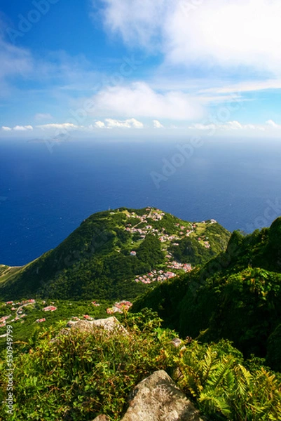Fototapeta Aerial view of Windwardside village from the Mount Scenery volcano on the Caribbean island of Saba in the Netherlands Antilles. Vertical view.