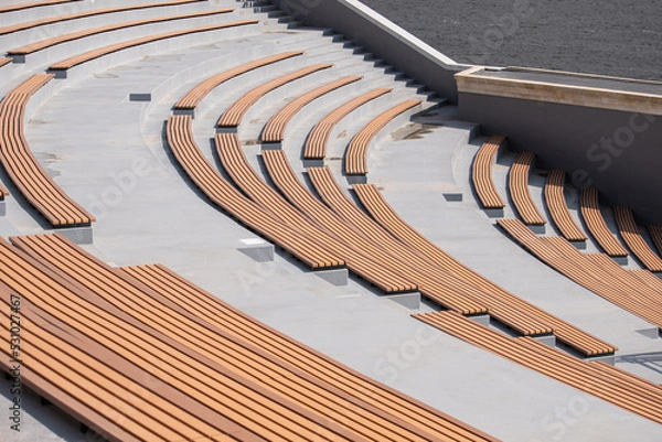 Fototapeta Amphitheater, benches for sitting, a place for citizens, the absence of people, the design of a city park, an observation deck, a place for spectator benches.