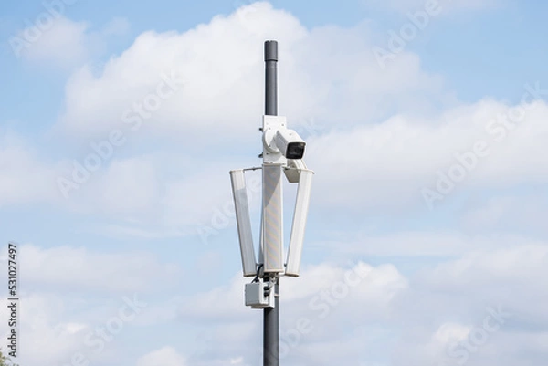 Fototapeta Surveillance camera in the area, street security, face recognition. Security system