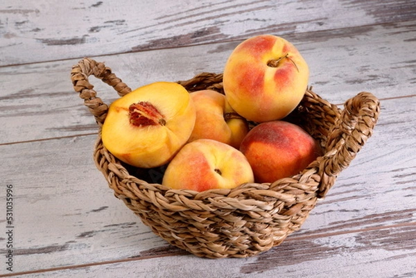 Fototapeta View of a bunch of peach fruits on wooden background.