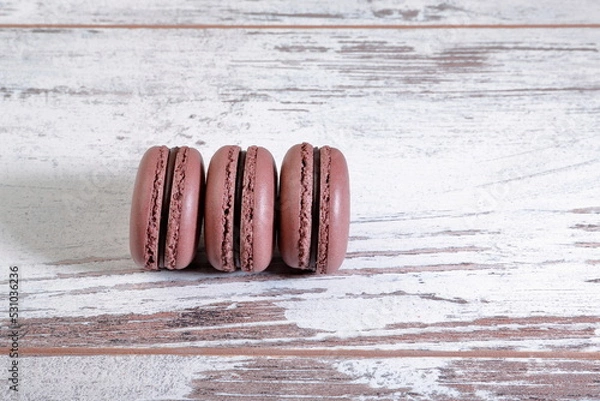 Fototapeta Cocoa macarons on wooden background.