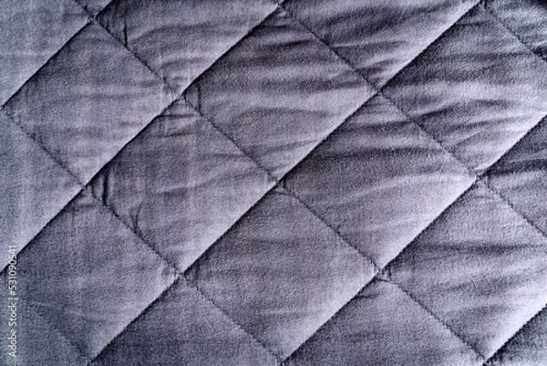 Fototapeta Grey blue weighted blanket texture detail, heavy padded relaxing bed sheet cover filled with glass beads