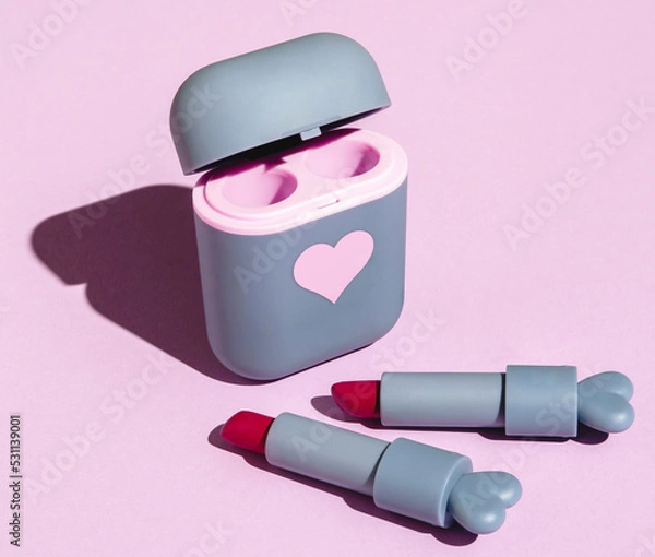 Fototapeta red lipstick in a cute gray case on a pink background with hard shadows