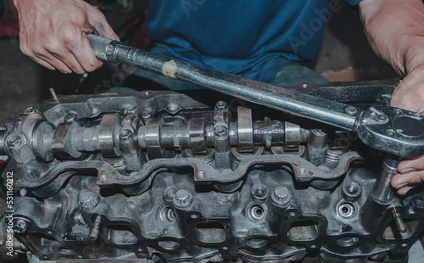 Fototapeta The mechanic is checking the engine.