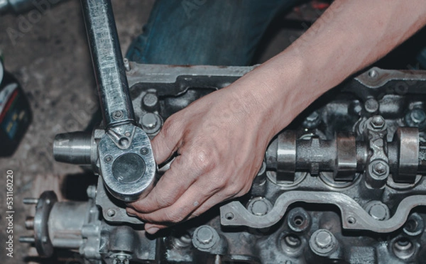 Obraz The mechanic is checking the engine.