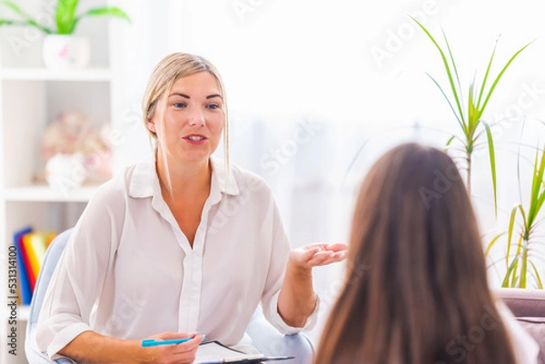 Fototapeta psychologist talks to the child, explaining and supporting at home, expressing emotions. an anxious teenage girl listens to a psychologist at a meeting talking about her problems. Successful therapy