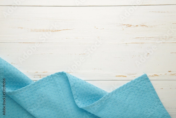 Fototapeta The checkered tablecloth on white background. Decorative blue cotton napkin.