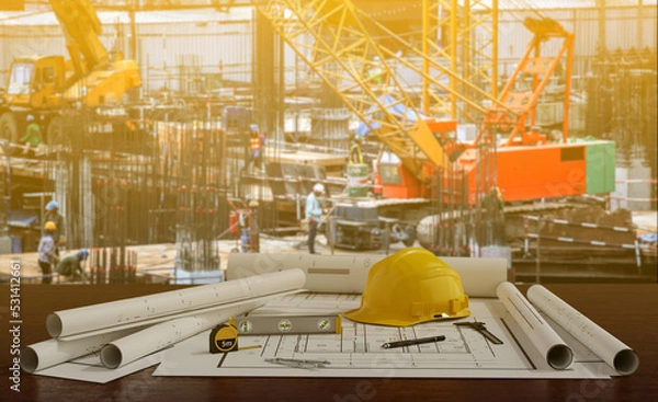 Obraz Blue prints with tool and  building under construction background.3D rendering