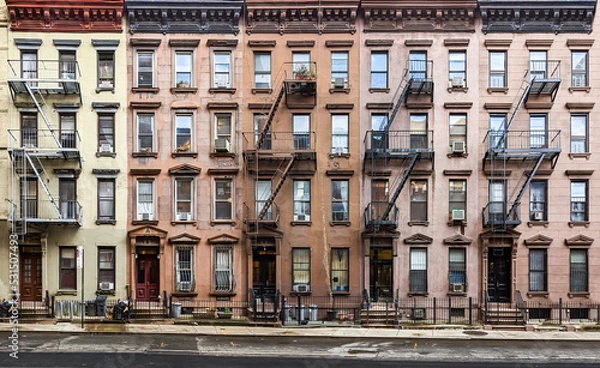 Fototapeta Block of historic apartment buildings crowded together on West 49th Street in the Hell's Kitchen neighborhood of New York City
