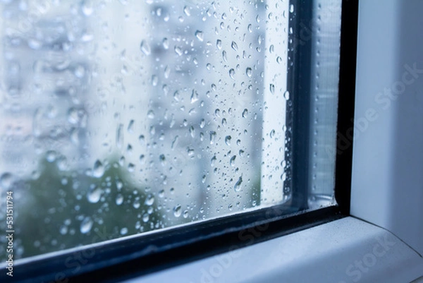 Obraz Drops on a double-glazed window, modern glass in the windows, rain outside the window, selective focus
