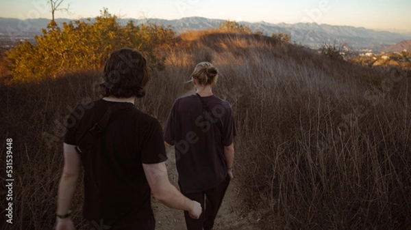 Obraz people walking through trail