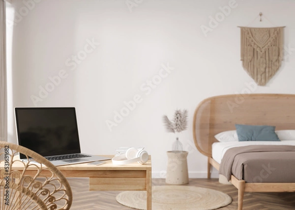 Fototapeta Laptop and headphones on table at home. Distance education, courses, online training, learning concept. Work from home, working online. Shopping via internet. E-commerce. Modern interior. 3D render.