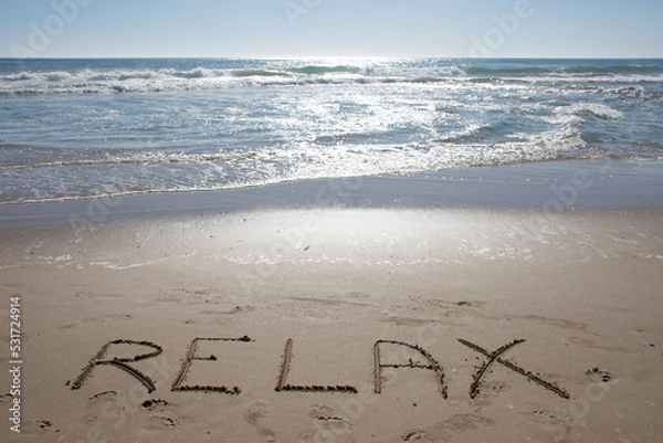 Fototapeta Empty Ocean View from the beach shore with relax word on the sand