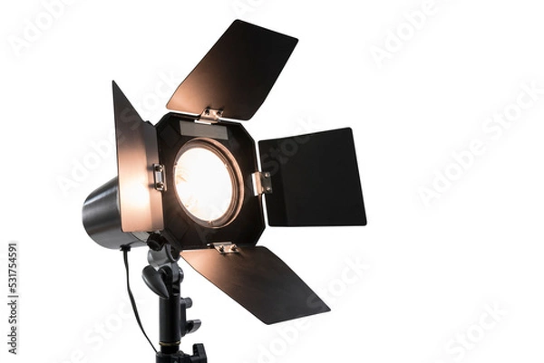 Fototapeta Glowing studio strobe light with barn doors isolated.