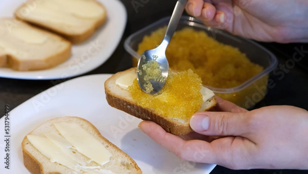 Obraz bread spread with salted pike caviar. close up