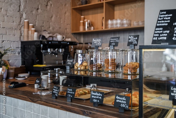 Obraz Shot of bar of coffee shop there are sweets croissants and coffee in daytime.