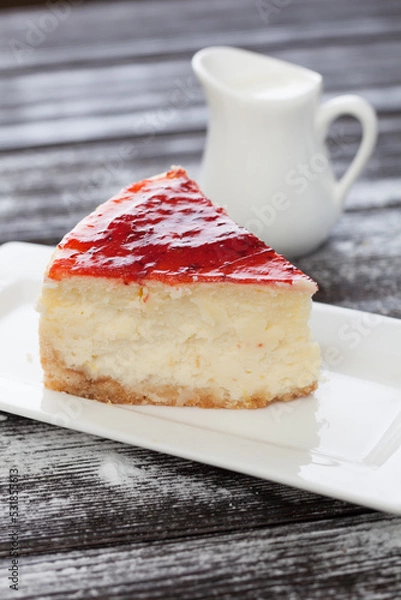 Obraz strawberry cheesecake and slice on table
