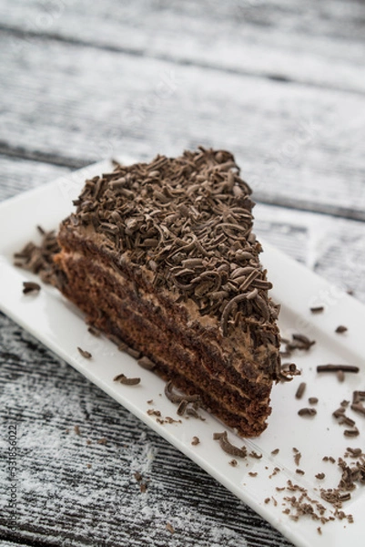 Obraz chocolate brown cake and slice on table