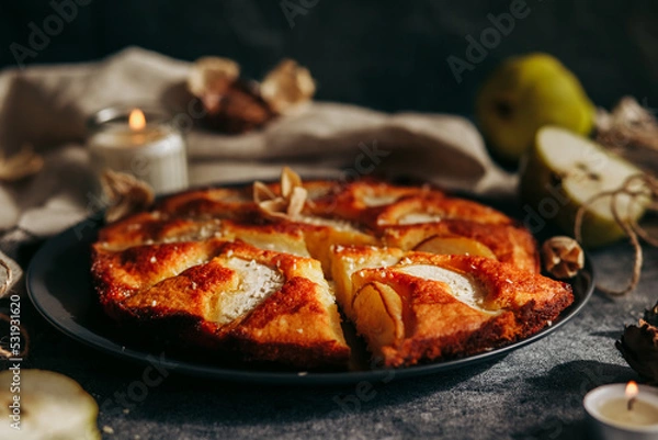 Fototapeta Cake with pear, honey and almonds. Delicious pie on a concrete table