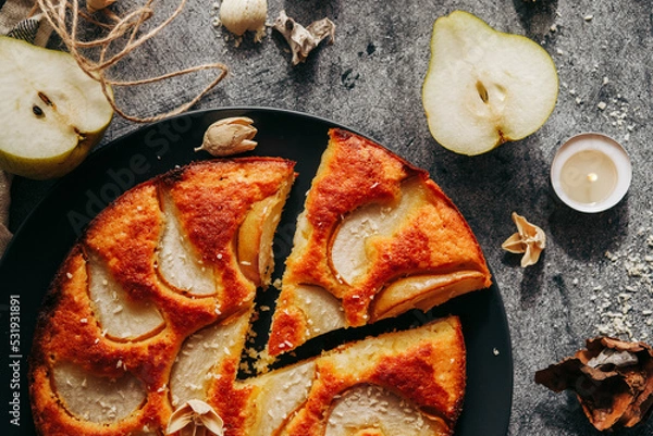 Fototapeta Cake with pear, honey and almonds. Delicious pie on a concrete table