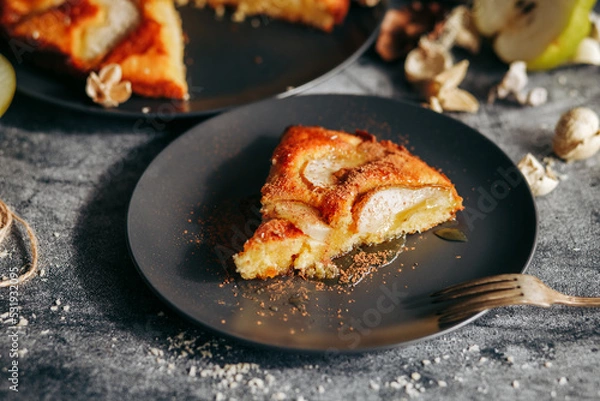 Fototapeta Cake with pear, honey and almonds. Delicious pie on a concrete table