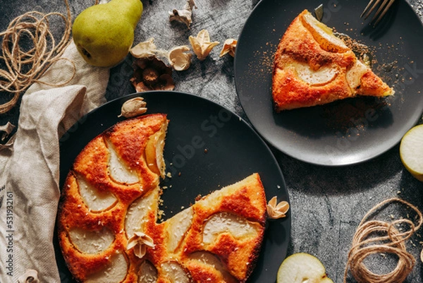 Fototapeta Cake with pear, honey and almonds. Delicious pie on a concrete table