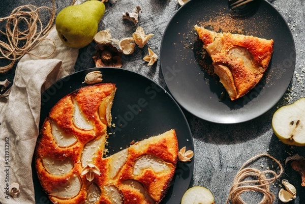 Fototapeta Cake with pear, honey and almonds. Delicious pie on a concrete table
