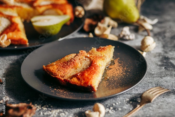 Fototapeta Cake with pear, honey and almonds. Delicious pie on a concrete table
