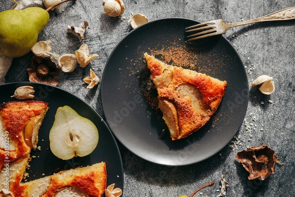 Fototapeta Cake with pear, honey and almonds. Delicious pie on a concrete table