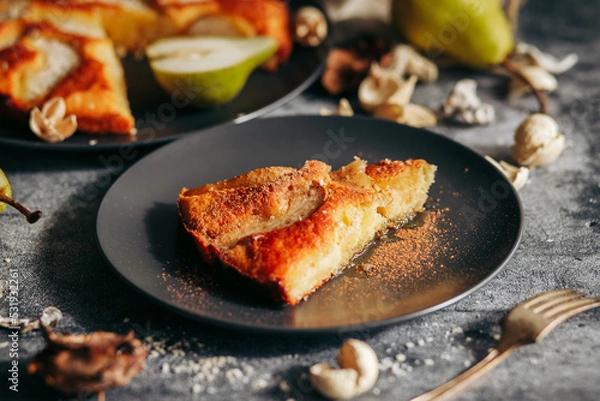 Fototapeta Cake with pear, honey and almonds. Delicious pie on a concrete table