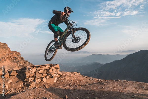 Fototapeta person riding a bike in the mountains