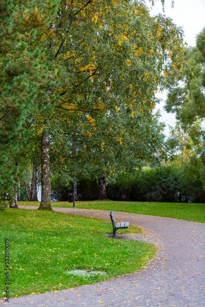 Obraz Autumnal park in Finland. An image of a beautiful park on an autumn evening, sun is about to go down and colorful trees and paths in fresh air invites people to walk.