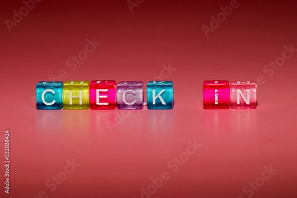 Fototapeta the word "check in" made up of cubes	