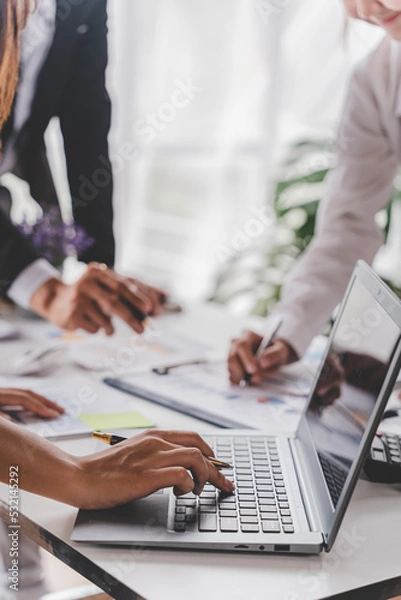 Obraz Young colleagues discuss business brainstorming and price charts analyze business people at the desk brilliantly in modern collaborative office teamwork ideas. Calculate personal tax for customers