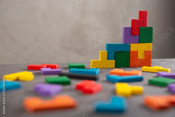 Fototapeta Creative idea solution - business concept, jigsaw puzzle on the grey background. Leadership and teamwork strategy success.