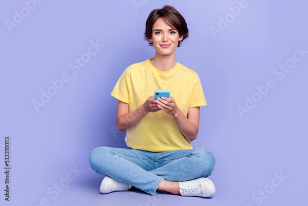 Fototapeta Full length photo of charming nice person sit floor hold use telephone isolated on violet color background