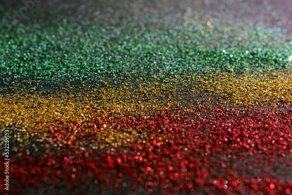 Fototapeta Black History Month concept. Abstract green yellow and red color glitter sparkle background. Space for your text.
