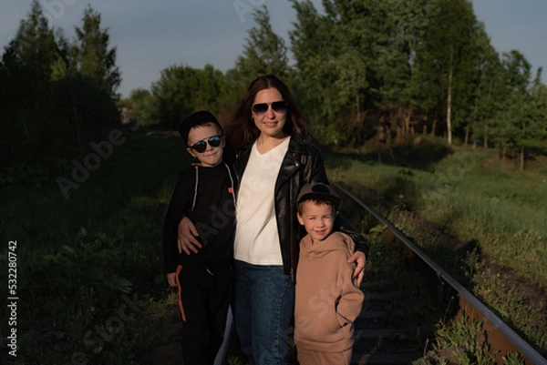Obraz young mother with sons in sunglasses smiling