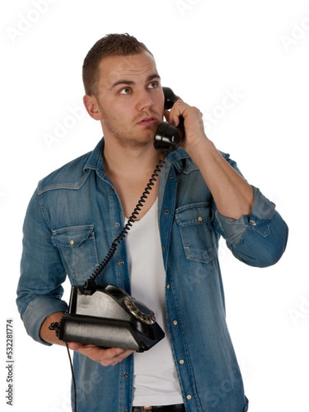 Fototapeta Young man making a phone call with an old telephone isolated on transparent background