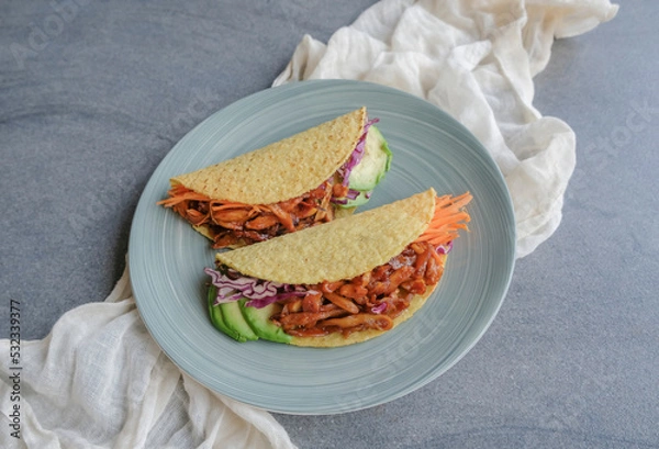 Obraz Homemade healthy snacks. Vegan Pulled Pork Taco Fold with Mixed Fruits Basket. Good for between meals snack, made from jackfruit flesh as pork, bbq sauce, purple cabbage, carrots taco shell