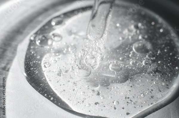 Fototapeta The pipette lies in a gel with air bubbles. Transparent gel structure with air bubbles, close-up. Gel in a Petri dish