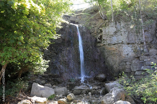 Obraz The Waterfall Area in downtown Petoskey, Michigan at Bayfront Park has a man-made waterfall, with the water running into Lake Michigan.