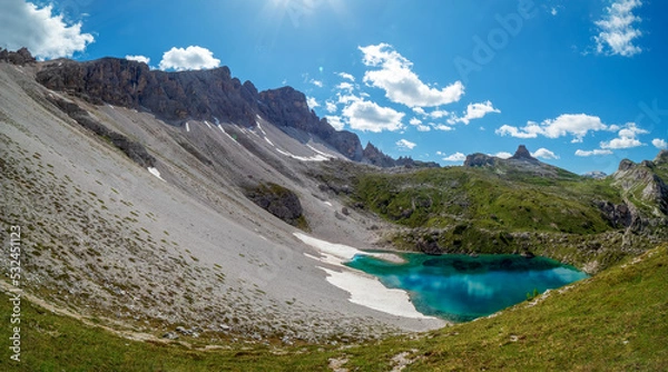 Fototapeta Panoramic mountain chain along the Tirol Sexten alps and lake with crystal clear drink water