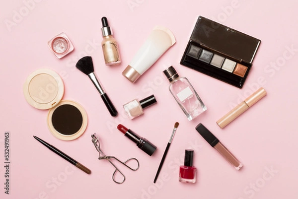 Fototapeta Different makeup products on color background, top view