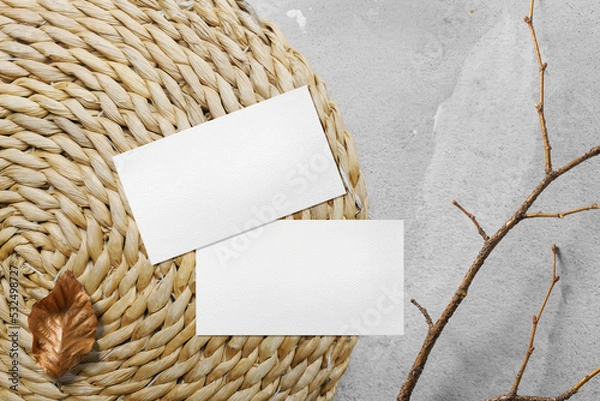 Fototapeta Clean minimal business card mockup on weave hyacinth with stick and leaf