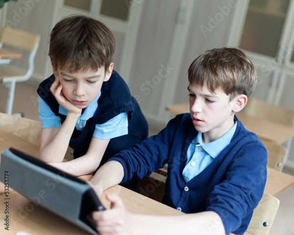 Fototapeta student and tablet in classroom