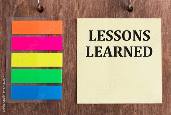 Fototapeta LESSONS LEARNED text on wooden background. business and education concept